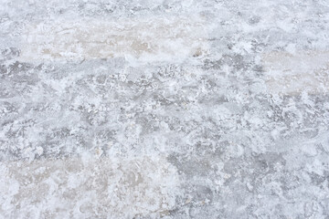 Obraz premium THE TEXTURE OF ICE ON THE SIDEWALK ON A WINTER DAY