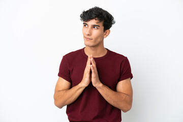 Young Argentinian man isolated on white background scheming something