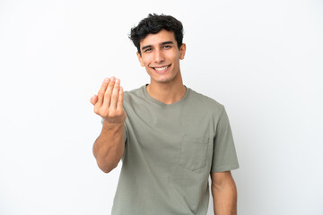 Young Argentinian man isolated on white background inviting to come with hand. Happy that you came - obrazy, fototapety, plakaty
