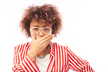 Curly young woman holding nose to avoid disgusted smell, pinches nose and mouth with fingers and...