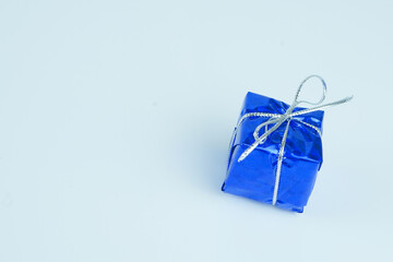 Metallic blue present with silver strings on a white background