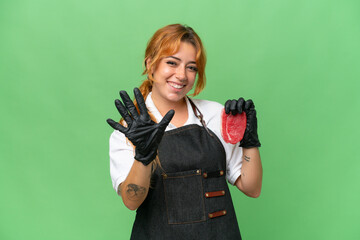 Butcher caucasian woman wearing an apron and serving fresh cut meat isolated on green screen chroma key background counting five with fingers - Powered by Adobe