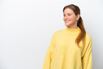 Young caucasian woman isolated on white background looking to the side and smiling