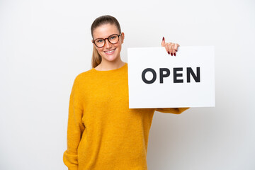 Young caucasian woman isolated on white background holding a placard with text OPEN with happy...