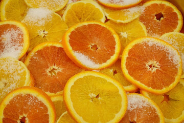 Orange slices sprinkled with sugar lie in layers in a copper basin for making jam.
Preparation of orange jam, orange slices with sugar in a copper basin