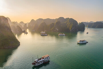 AERIAL VIEW FLOATING FISHING VILLAGE AND ROCK ISLAND, HALONG BAY, VIETNAM, SOUTHEAST ASIA. UNESCO WORLD HERITAGE SITE. JUNK BOAT CRUISE TO HA LONG BAY. POPULAR LANDMARK, FAMOUS DESTINATION OF VIETNAM © Hien Phung