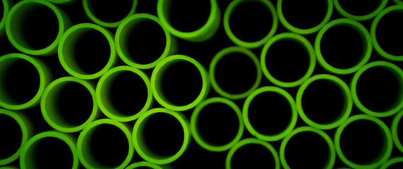 Background of the green plastic pipes in stacked
