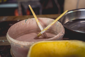 Jars with acrylic paints at a workshop