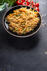 rice noodles with vegetables Asian dish fresh delicious snack healthy meal food snack diet on the table copy space food background rustic top view keto or paleo diet veggie vegan or vegetarian food 