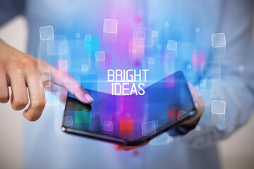 Young man holding a foldable smartphone