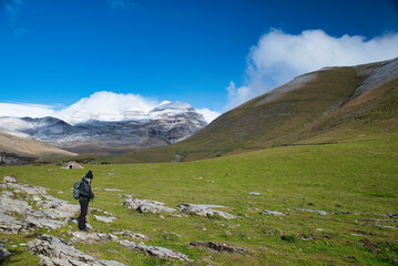 Lonely hiker girl in Monte Perdido with the mountains in the background. The three Sorros