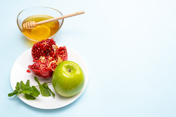 Jewish New Year Rosh Hashanah Traditional background with green apple, ripe pomegranate and honey