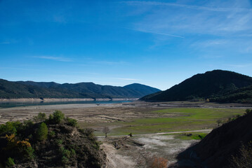 Drought in Spain. Effects of climate change such as desertification and droughts. El Mediano reservoir with little water. Huesca. Spain. November 2022.