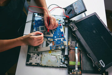 computer technician Laptop Motherboard Repairman Using IC Meter To Find Faults On Motherboard To...