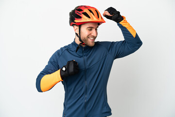 Young cyclist man isolated on white background celebrating a victory