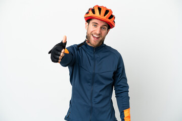 Young cyclist man isolated on white background with thumbs up because something good has happened