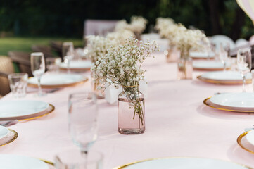 On the table is a decorative vase with dried flowers. Beautiful summer location for relaxation