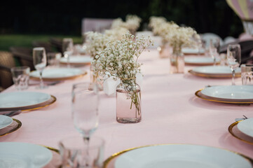 On the table is a decorative vase with dried flowers. Beautiful summer location for relaxation