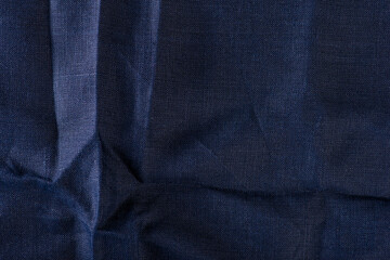 Texture of fabric for furniture upholstery. Wear and water resistant fabric in deep folds top view. Blue fabric texture closeup top view.