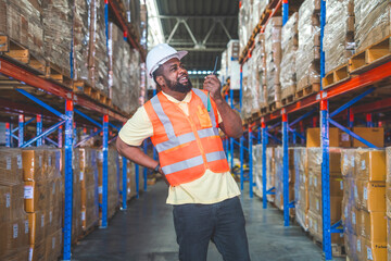 Black worker working holding walkie talkie feeling sudden back pain standing in logistics factory