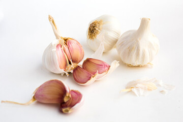 garlic heads and cloves on white background