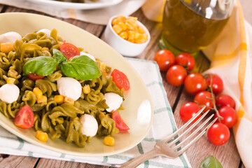 Fusilli pasta with cherry tomatoes and sweet corn.