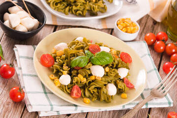 Fusilli pasta with cherry tomatoes and sweet corn.