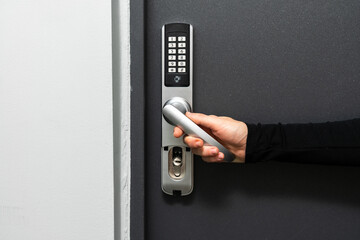 Woman hand push the door handle down
