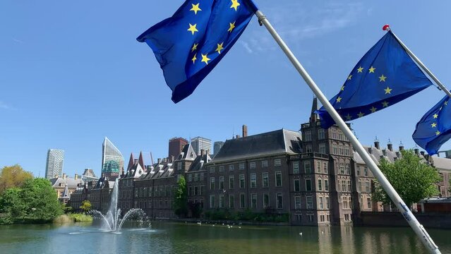 View of Binnenhof. Dutch government and office of Prime minister. Europen Union (EU) flags are waving in front. Running fountain. Den Haag skyline. The Hague, South Holland, Netherlands