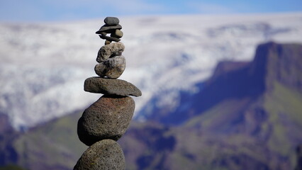 tall cairns in rural iceland with glacier backdrop