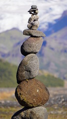 tall cairns in rural iceland with glacier backdrop
