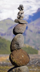 tall cairns in rural iceland with glacier backdrop