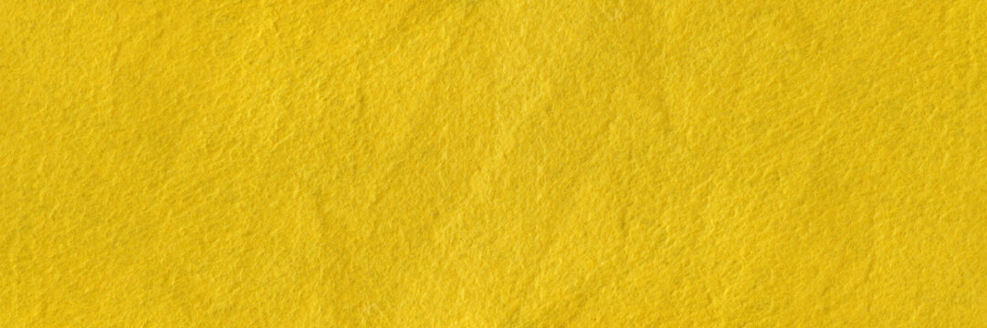 Texture of yellow felt. Abstract background with yellow felt. High resolution photo.