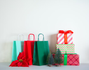 Christmas New Year paper bags and gift boxes. Sales and shopping concept. Copy space.