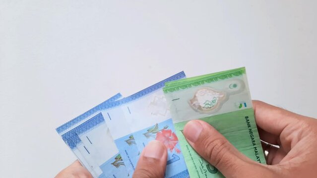 Hands counting Malaysian ringgit money
