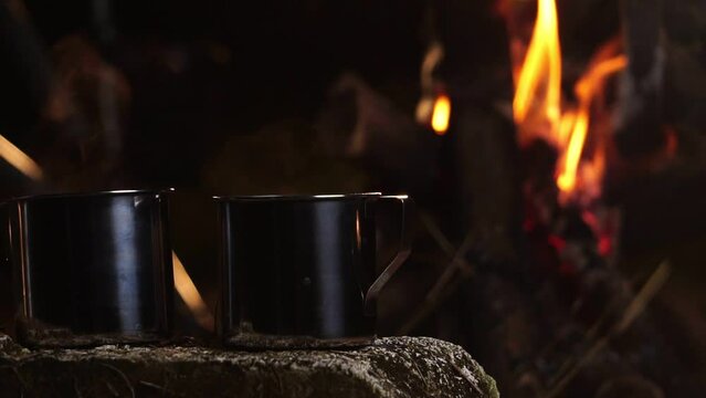 Seniors Camping At Night, Resting On His Winter Vacation, A Mug Of Warm Water, Around A Campfire