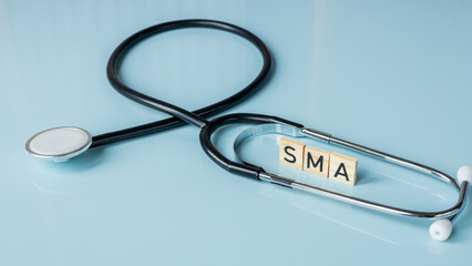 SMA, spinal muscular atrophy, Written on wooden blocks, a rare disease in which, due to a genetic...