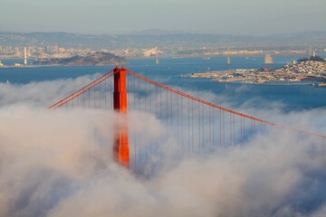 Scenic view of the Golden Gate Bridge hidden in the clouds on the background of the city