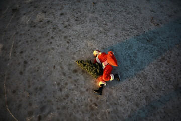 Santa Claus hurries to meet the New Year with gifts and Christmas tree. Santa Claus on ice skates goes to Christmas.