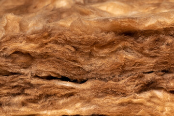 Isolated closeup of fiberglass insulation. Home energy savings, heating and cooling costs and construction concept.