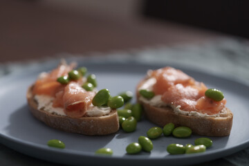 Bruschettas with cream cheese and salmon on dining table