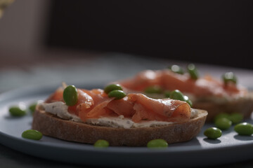Bruschettas with cream cheese and salmon on dining table