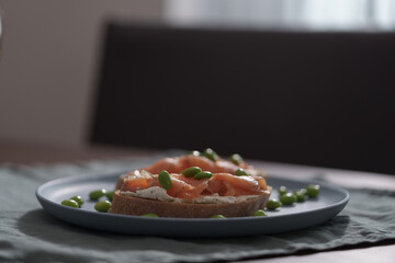 Bruschettas with cream cheese and salmon on dining table