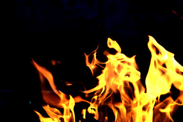 Fototapeta na wymiar Background of the flame in the oven. Tongues of fire in a fireplace. Fire texture.