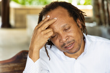 tired middle age African man having headache