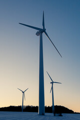 low angle view of wind turbines against the sky at down