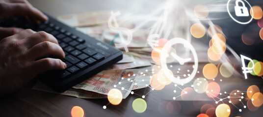 Russian rubles are on the table next to the computer, Notepad in the office or Bank. Savings and investments in the conditions of sanctions and inflation.