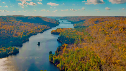 Autumn forest on the riverside, beautiful trees and blue river. Fall colors. View above. New England fall foliage in Connecticut (Falls Brook Falls Trail, near Hartland)