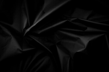 Black nylon texture. minimalist and elegant crumple textile. simple dark background