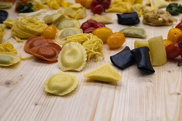 Freshly Made Raw Tortelli and Other Types of Italian Pasta over Wooden Table